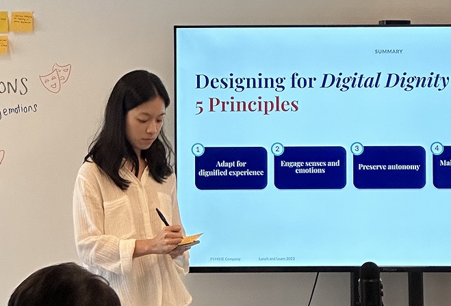 A talk in progress, with a slide titled ‘Designing for Digital Dignity: 5 Principles’.