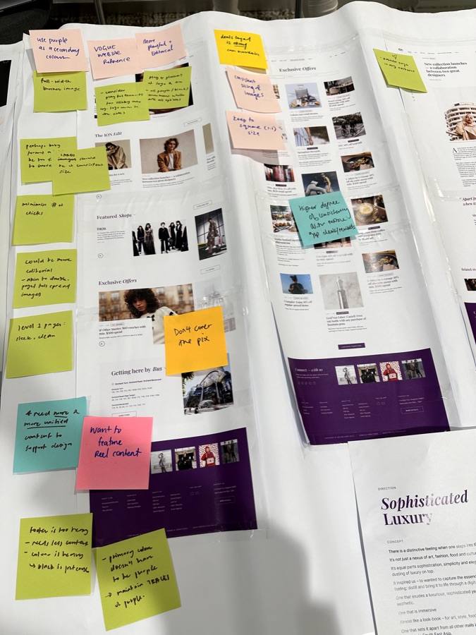 More printed layouts covered in handwritten sticky-note feedback.